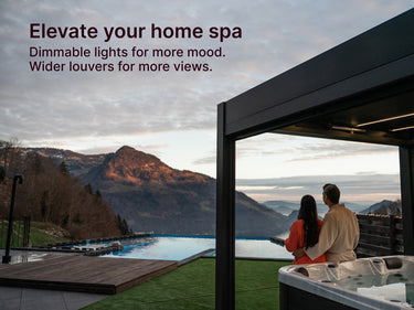 Couple by a hot tub overlooking a scenic mountain view.