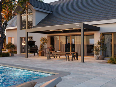 Patio area with pergola, pool, and outdoor furniture in a residential setting