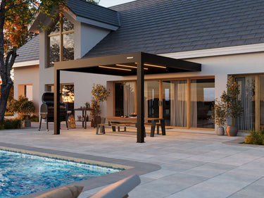 Patio with pergola, pool, and outdoor furniture in a residential setting