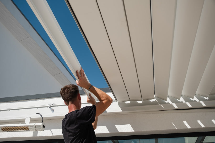 Professional installing roof louvres on a PERGOLUX pergola